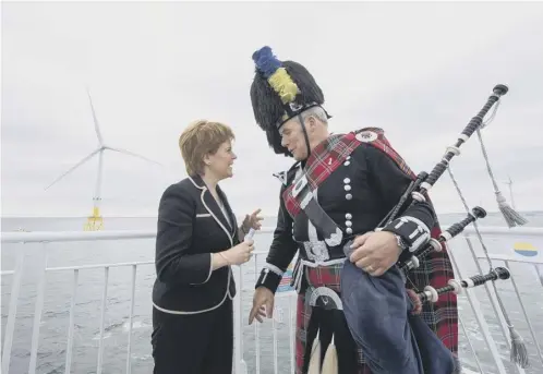  ??  ?? Nicola Sturgeon chats with piper Norman Fiddes at the opening of Vattenfall’s European Offshore Wind Deployment Centre