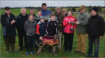  ??  ?? John Saunders, Jonathan Best and Michael Kelliher pictured receiving the cup from the Murphy family after his dog, Bower Judy, won the Mikey Murphy Cup at Lixnaw last Sunday.
Photos by David O’Sullivan