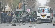  ?? AP PHOTO/RAHMAT GUL ?? Afghan security personnel inspect the site of a bomb attack in Kabul, Afghanista­n, on Saturday.