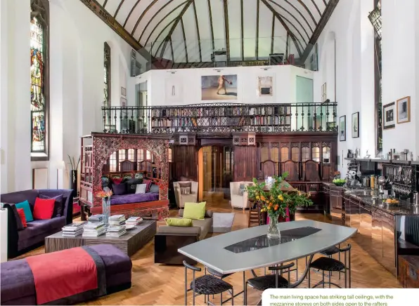 ??  ?? The main living space has striking tall ceilings, with the mezzanine storeys on both sides open to the rafters