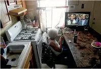  ?? AP ?? Carrie Newson watches television in her home at the Dutch Village apartments, in Baltimore. Newson has complained to management about mice and mould in her home, but the issues have yet to be fixed. The apartment complex is owned by Jared Kushner, son-in-law of President Donald Trump. Right, mice droppings in a corner of Newson’s living room.