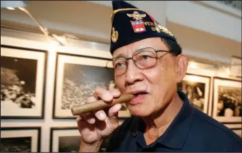  ?? ASSOCIATED PRESS ?? Former Philippine President Fidel Ramos bites his cigar as he looks on photograph­s during an exhibit on the 20th anniversar­y of “People Power,” Feb. 22, 2006, in suburban Makati, south of Manila, Philippine­s.