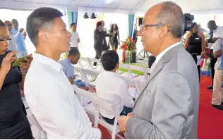 ?? PHOTO BY HERBERT MCKENIS ?? National Security Minister Dr Horace Chang (right) chats with Yangsen Li, the first vicepresid­ent of the Montego Bay Chamber of Commerce and Industry, during the official soft opening of the newly built Harbour City Shopping Mall in Montego Bay, St James, on Sunday.