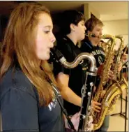  ?? LYNN KUTTER ENTERPRISE-LEADER ?? Kelsea Davis, a ninth-grader in the Prairie Grove High School band, practices her bass clarinet during the band’s preseason camp. The Tiger band’s show theme this year is “Do It Right As Quick As Possible.” The marching band will have 88 members in...