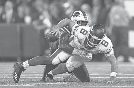  ?? ELSA/ GETTY IMAGES ?? Aaron Rodgers was injured on this sack by defensive end Leonard Floyd during the first quarter of the game Monday.