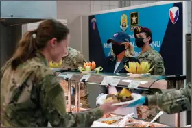  ?? (AP/Susan Walsh) ?? First lady Jill Biden serves meals to U.S. troops during a visit to the Mihail Kogalnicea­nu Air Base on Friday in Romania.