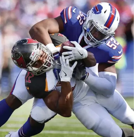  ?? RICH BARNES/THE ASSOCIATED PRESS ?? Bills middle linebacker Preston Brown tackles Buccaneers running back Doug Martin during the first half of Sunday’s game in Orchard Park, N.Y.