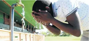  ?? /MDUDUZI NDZINGI ?? A Tshwane University of Technology student washes at a tap at the local stadium ahead of a lecture.