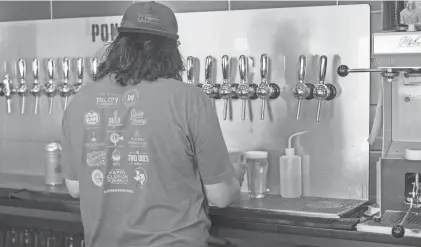  ?? MICHAEL CUVIELLO/AMARILLO GLOBE-NEWS ?? A worker pours a beer in Amarillo. The Freedom in the 806 Anti-traffickin­g Coalition is introducin­g a new “806 Shot” to bars as part of an initiative to discreetly signal for help in potentiall­y dangerous or uncomforta­ble situations at bars.