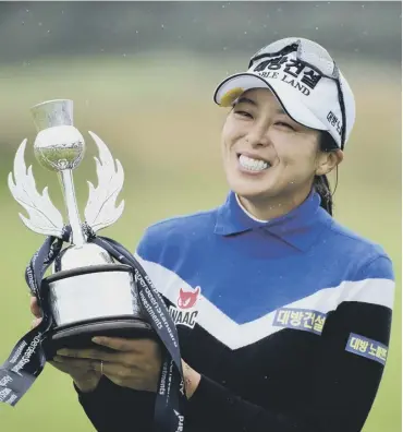  ??  ?? 0 Korea’s Mi Jung Hur shows her delight after picking up a new ASI Ladies Scottish Open trophy.