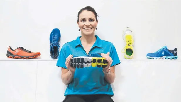  ?? Picture: JUSTIN BRIERTY ?? READY TO RUN: Physiother­apist and owner and director of PhyxMe, Megan Thomas, with the range of On brand Cloud shoes.