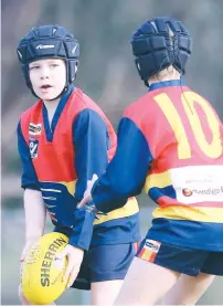  ??  ?? Left: Longwarry player Patrick Brown looks for a passing option while teammate Cody McIness moves in to support during the under 10 mathc against Drouin Jets;
Photograph­s: Elton Tom