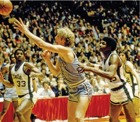  ?? ?? Larry Bird finished with 19 points and 13 rebounds, but the national championsh­ip was just out of reach for his Indiana State Sycamores in their 75-64 loss to Magic Johnson (left, who had 24 points, seven rebounds and five assists) and Michigan State.