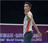  ?? AFP ?? Kento Momota of Japan celebrates after defeating Shi Yuqi of China in the men’s singles final. —