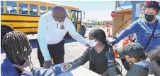  ?? JESSICA HILL/ASSOCIATED PRESS ?? High school senior Sudeen Pryce receives support as EMT Katrinna Greene administer­s the first dose of the Pfizer vaccine in Connecticu­t.