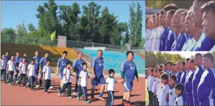  ?? XINHUA ?? Tacheng United players lead kids into a playground to let them experience the soccer atmosphere in the border town in northwest China’s Xinjiang Uyghur autonomous region. The club aims to grow the sport and get more kids involved in playing it in the...