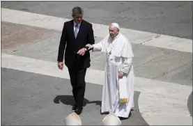  ?? GREGORIO BORGIA — THE ASSOCIATED PRESS ?? Pope Francis is helped walking at the end of the canonizati­on mass for ten new saints in St. Peter’s Square May 15 at The Vatican.