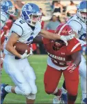  ??  ?? Jeremy Stewart / RN-T
Armuchee running back Adam Hart (left) works to break away from LFO’s Braxton Jones during Friday’s game at Armuchee.