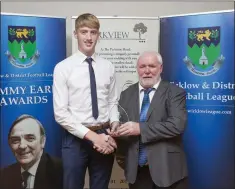  ??  ?? Liam Kilbride presents Oisin McGraynor of Avonmore FC with the John Tobin Youth Player of the Year award.