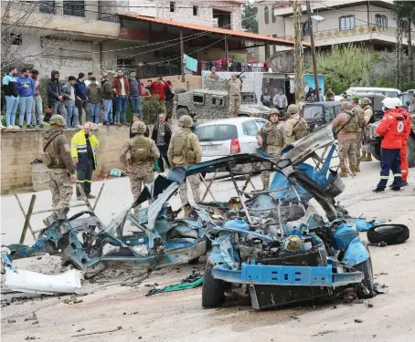  ?? AFP ?? Lebanese soldiers cordon off the site of an Israeli drone attack targeting a vehicle in western Bekaa Valley amid ongoing cross-border tensions.