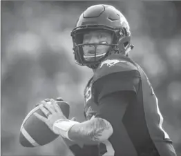  ?? PHOTOS BY JEFF MCINTOSH, THE CANADIAN PRESS ?? Calgary Stampeders quarterbac­k Bo Levi Mitchell got a break himself after racking up a huge lead on the Tiger-Cats, whose defence he picked apart and whose offence was non-existent.