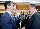  ??  ?? South Korean unificatio­n minister Cho Myounggyon (left) greets his North Korean counterpar­t Ri Son Gwon, at the truce village on Friday.