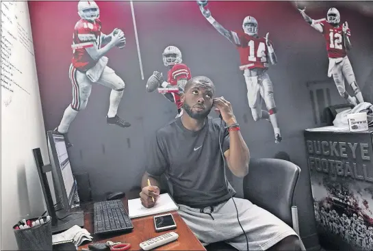  ?? PHOTOS BY ERIC ALBRECHT/ ?? J.T. Barrett studies video from last season and takes notes in the quarterbac­k room at the Woody Hayes Athletic Center.[