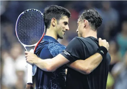  ?? PHOTO: GETTY IMAGES ?? Nice try . . . Novak Djokovic, of Serbia, hugs John Millman, of Australia, after their US Open men’s singles quarterfin­al at the USTA Billie Jean King National Tennis Centre in New York yesterday.