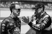  ?? ASSOCIATED PRESS ?? KEVIN HARVICK (LEFT) talks with Aric Almirola during qualifying for the NASCAR Cup Series auto race Saturday at Talladega Superspeed­way in Talladega, Ala.