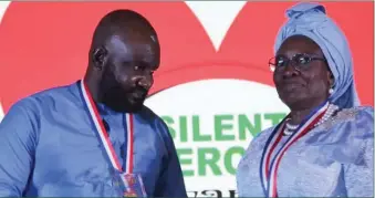  ?? ?? Former Minister of Women Affairs, Dame Pauline Tallen presenting Silent Hero in Business and Industry award to Deacon Sunday Chukwumanj­o Umeoduagu, CEO of GABJANE Global Resources Limited