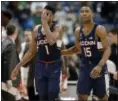  ?? JESSICA HILL — THE ASSOCIATED PRESS ?? UConn’s Christian Vital, left, and Rodney Purvis react during the second half of Saturday’s loss to Cincinnati.