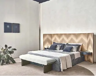  ?? ?? And so, to bed: Eve double bed with boiserie headboard in “Colore” Frisé walnut herringbon­e wood inlay with adjustable side panels designed by Pietro Russo for Gallotti & Radice