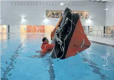  ?? DAVE JOHNSON/ WELLAND TRIBUNE ?? Outgoing Port Colborne Marine Auxiliary Rescue unit executive officer Zach Walters practices righting a life raft before pulling himself onboard Sunday.