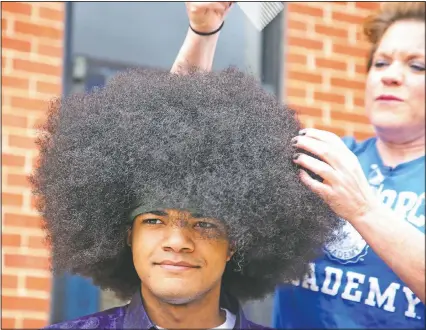  ??  ?? Moise has his 19-inch hair prepared to be cut. So far “Kieran’s Curls for Cancer” has raised $35,000.