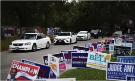  ??  ?? A line of cars drive in for an event encouragin­g community members to vote in the upcoming election at an early voting site in Houston, Texas, on 25 October. Photograph: Callaghan O’Hare/Reuters