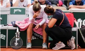  ?? ?? Simona Halep receives medical attention during her match with Zheng Qinwen. Afterwards Halep admitted she put too much pressure on herself. Photograph: Shi Tang/Getty
