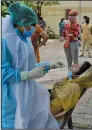  ?? (AP/Ajit Solanki) ?? A woman gets a nasal swab Thursday in Ahmedabad, India, as the country’s coronaviru­s cases surged close to 1 million.