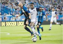  ?? PAUL CHIASSON/THE CANADIAN PRESS/FILES ?? Impact defender Laurent Ciman, left, says Sunday’s game against the first-place Toronto FC is all about moving up in the MLS standings.
