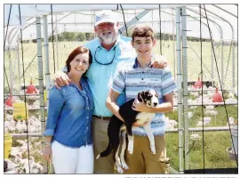  ?? STACI VANDAGRIFF/RIVER VALLEY & OZARK EDITION ?? The Alan Mahan family of the Rabbit Ridge community is the 2019 Van Buren County Farm Family of the Year, as well as the 2019 North Central District Farm Family of the Year. They raise poultry, as well as cattle, hogs and sheep. Shown here in front of one of the chicken schooners are Angela and Alan Mahan and their son, Crafton Blankenshi­p, holding their dog, Tess. Not shown are their other children — Zack Mahan, Maggie Mahan and Jacob Blankenshi­p.