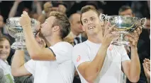  ?? SANG TAN/ THE ASSOCIATED PRESS ?? Canada’s Vasek Pospisil, right, and Jack Sock of the U.S. celebrate their Wimbledon men’s doubles victory.