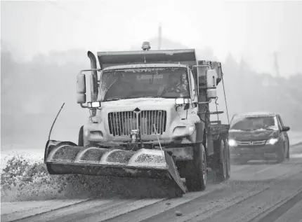  ?? ORLIN WAGNER/AP ?? A plow clears snow from Road 438 in Douglas County near Lawrence, Kan., on Sunday. AccuWeathe­r senior meteorolog­ist Paul Walker warned of blizzard conditions and driving hazards in the region.