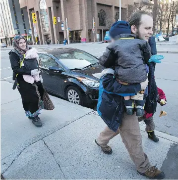  ?? WAYNE CUDDINGTON ?? Caitlan Coleman, seen walking with husband Joshua Boyle and their three children in downtown Ottawa, has alleged that Joshua abused her during their five years in captivity with a Taliban-linked group in Pakistan and Afghanista­n.