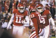  ?? Sue Ogrocki / Associated Press ?? Oklahoma’s Parnell Motley (11) celebrates after intercepti­ng a pass in overtime against Army.