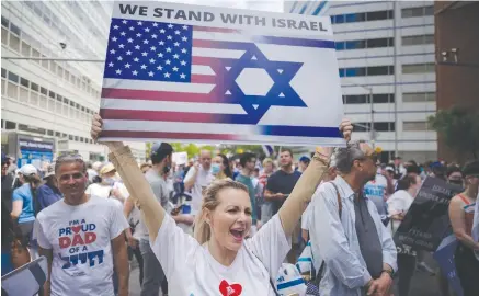  ?? (Ed Jones/AFP/Getty Images/TNS) ?? PRO-ISRAEL DEMONSTRAT­ORS attend a rally denouncing antisemiti­sm and antisemiti­c attacks, in Manhattan, last month.