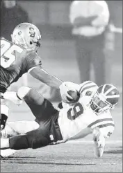  ?? Michael Robinson Chavez Los Angeles Times ?? CHASE FORREST, right, being tackled by St. Bonaventur­e’s Mark Zavala in playoff game last season, is back at quarterbac­k for Santa Ana Mater Dei.