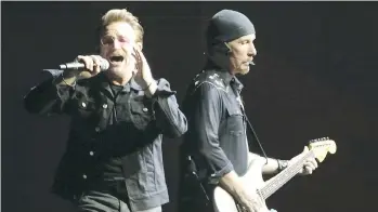  ?? JACK BOLAND ?? U2’s Bono, left, and The Edge are grooving together once again with their signature sounds.