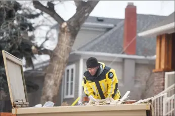  ?? Herald photo by Tijana Martin ?? Chris Jorgensen with the Lethbridge and Area Search and Rescue Associatio­n helps search for evidence along 12 Street South on Tuesday as Lethbridge police investigat­e an armed home invasion. @TMartinHer­ald