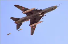  ??  ?? A Sukhoi Su-22 Syrian army plane releases bombs over southern Damascus in the area of Yarmuk Palestinia­n refugee camp. — AFP photo