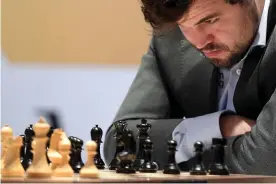  ?? Yoshua Arias/EPA ?? Magnus Carlsen studies the board during game 11 of the World Chess Championsh­ip. Photograph: