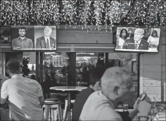  ?? OCTAVIO JONES / REUTERS ?? The dual town halls of US Democratic presidenti­al candidate Joe Biden and US President Donald Trump are seen on television monitors at a restaurant in Tampa, Florida, on Thursday.